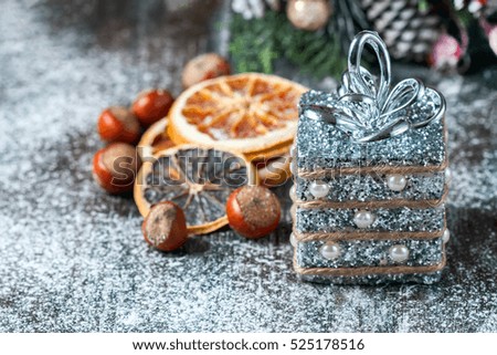 Silver and white xmas ornaments on rustic wood background. Merry christmas card. Space for text. Selective focus