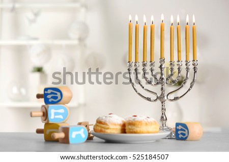 Beautiful composition for Hanukkah on grey table against blurred background