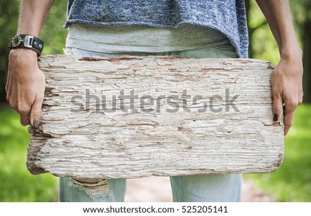 Woman holding empty wooden board outdoor. Template mock up