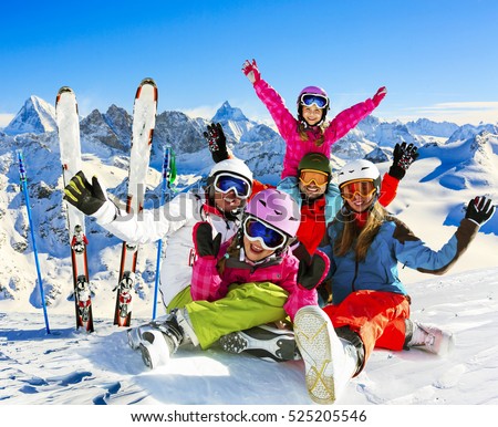 Skiing family enjoying winter vacation on snow in sunny cold day in mountains and fun. Switzerland, Alps. Composite photo. Royalty-Free Stock Photo #525205546