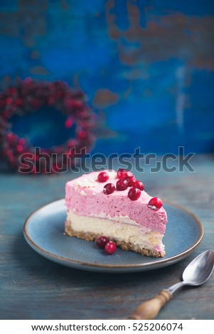 Festive cranberry cheescake with fresh berries. Shallow depth of field, copy space.