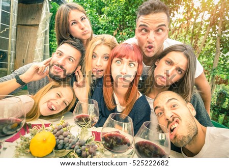 Best friends taking selfie at lunch party with funny faces - Happy youth concept with young people having fun together drinking wine - Cheer and friendship at grape harvest time - Bright vivid filter