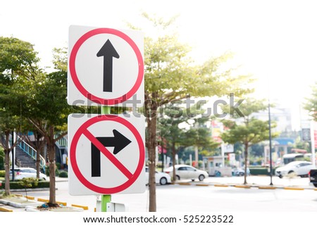 close up road sing go straight and don't turn right, outdoor and blur background Royalty-Free Stock Photo #525223522