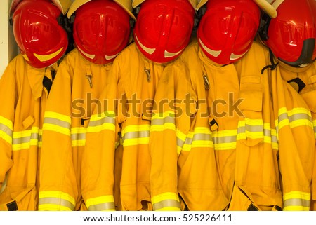 Firefighters in yellow fire-proof uniform Royalty-Free Stock Photo #525226411