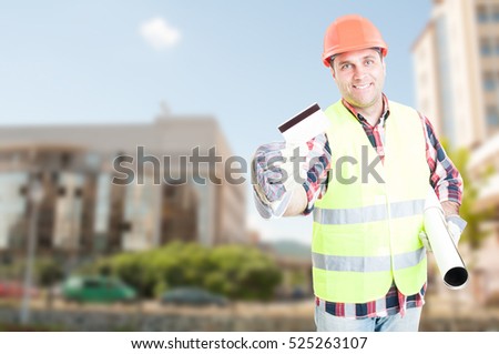 Construction engineer holding house project and showing debit card as payment concept with advertising area