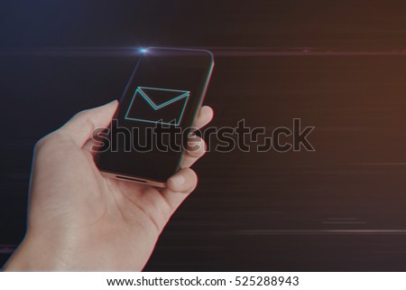 Close up of man hand holding smart phone with E-Mail Icon on Light Motion Background and Lens Flare - Digital 3d Effect Style Color