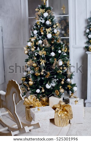golden Toy horse near a Christmas tree and chimney in a cozy room