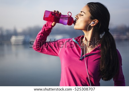 Fitness woman drinking water  Royalty-Free Stock Photo #525308707