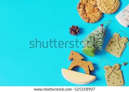  Cookies, Christmas tree and a toy horse, pine cone, bauble. New Year background. Winter holiday concept. Ideas for the purchase of gifts. Flat lay border, top view photo. Copy space