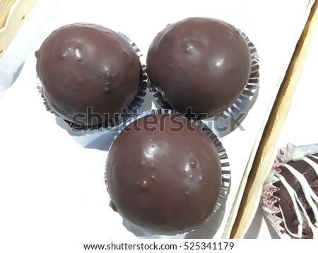 Picture of assorted donuts in a box with chocolate frosted Delicious donuts on paper background