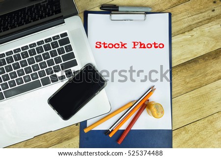 Stock Photo word at note pad in wooden table . 