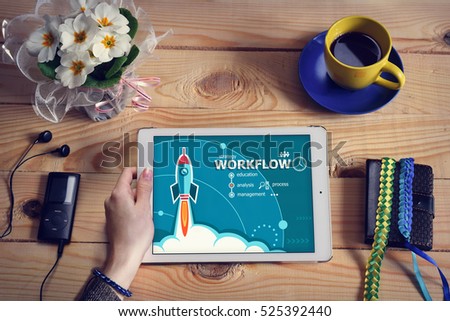 Laptop computer, tablet pc and Workflow design concept on wooden office desk with copy space. Design concept background with rocket. 