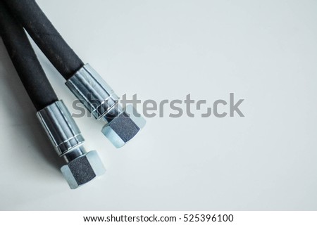 Hydraulic metal hose ends on white background. Closeup macro detail Royalty-Free Stock Photo #525396100