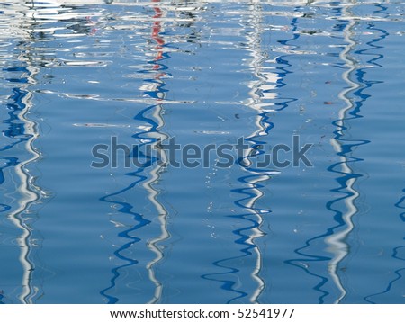 Picture presents a reflection of boats on sea