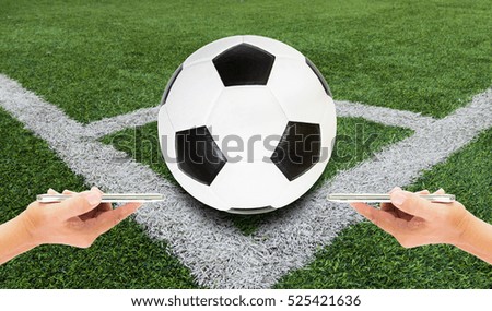 Man use mobile phone, image of football on field as background.
