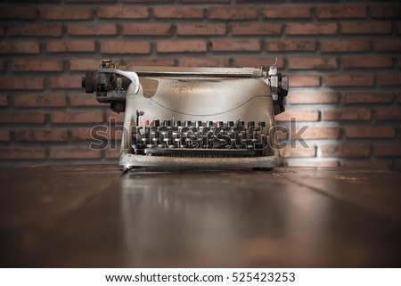 Type writer on the wood table in retro concept