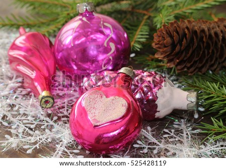 Pink balls for Christmas trees , decorations on the background of fir branches .