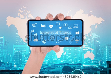 woman hand using smart phone in concept internet of things with night modern city background