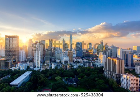 Aerial view of Bangkok modern office buildings, condominium in Bangkok city downtown with sunset sky ,Bangkok is the most populated city in Southeast Asia.  Royalty-Free Stock Photo #525438304