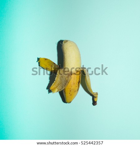 little bananas on colored background, minimal pop theme, direct flash used