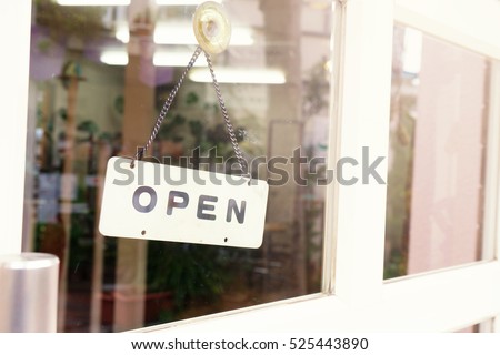 Wording "open" label put on clear glasses door or window.Open daily letter wording sign sticker is symbol use for tell customer mostly put on front door of shop store and office.image use flare filter