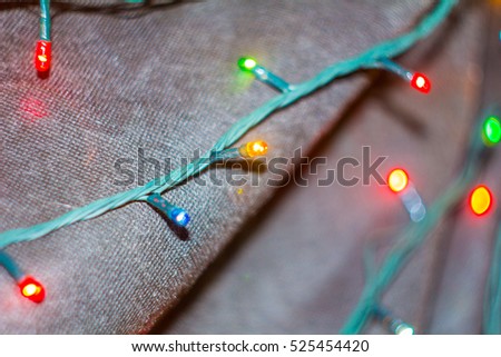 Christmas garland bulbs closeup on dark blur background
