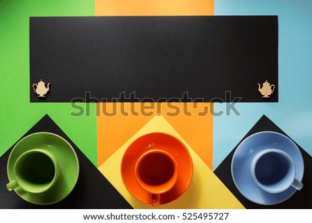cup and saucer at colorful paper background