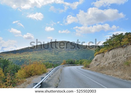 A girl stands on the roadside in the mountains. Crimea