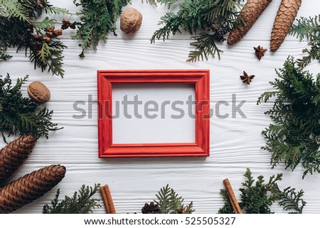 Christmas decoration on the white wooden background. Woman holding a photo frame.