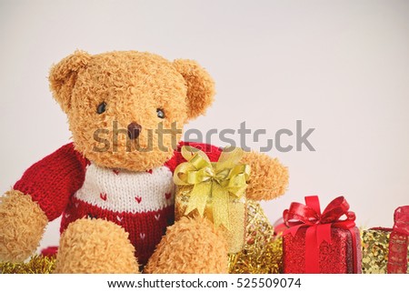Teddy Bear wearing red knitted sweaters with Christmas Gift Boxes.Creative for colorful greeting card with copy space. Merry Christmas