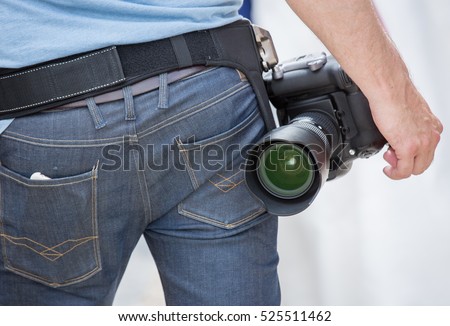 Professional photographer with a belt clip for his camera