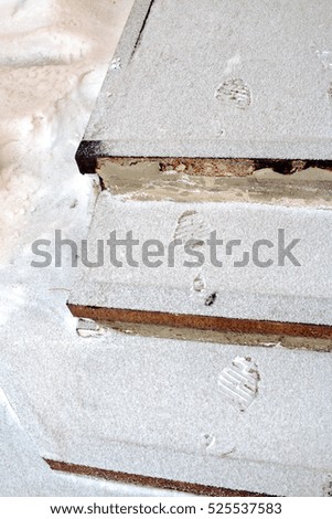 Human footprints on the snowy stairs in winter.