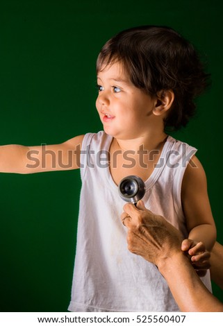 a child in examination room with green screen