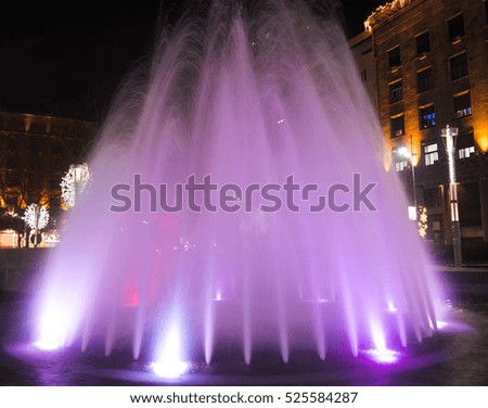 Beautiful violet fountain with New Year decoration on Nikola Pasic Square in Belgrade, long exposure, night photo