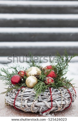 Green with red and golden Christmas conifer wreath with copy space.
