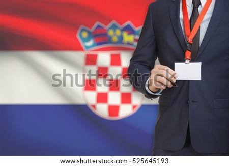Businessman holding name card badge on a lanyard with a flag on background - Croatia