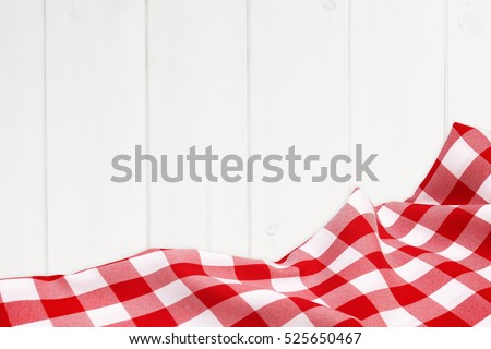 Red holiday tablecloth on the wooden white boards