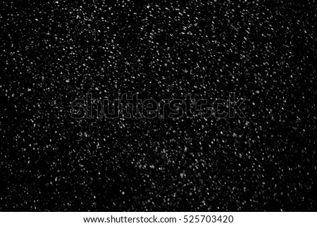 Falling snow on dark sky background texture to paste in photoshop in winter pictures. 