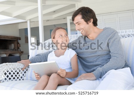 Father and daughter using tablet