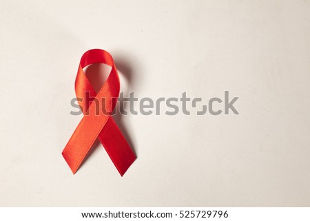 AIDS ribbon on white Royalty-Free Stock Photo #525729796