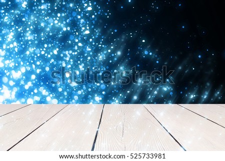 Blue bokeh or particle lights. Christmas background. Place for display your product