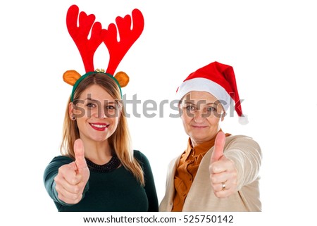 Picture of two happy ladies wearing Christmas costumes, showing thumbs up