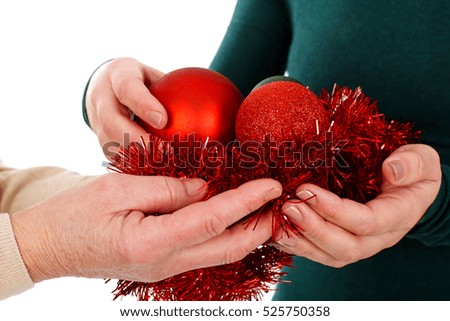 Close up picture of woman holding Christmas decoration on an isolated background