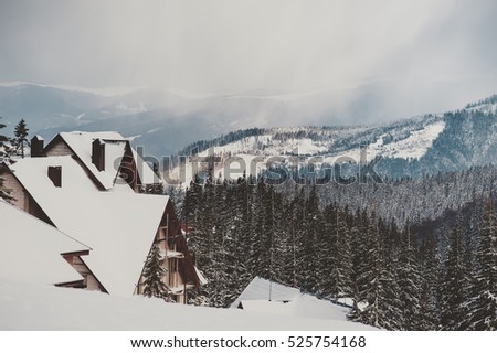rural wooden building on mountain top at ski resort. vintage picture. winter wallpaper