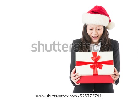 Christmas business woman opening gift surprised and happy, Young beautiful smiling woman in Santa hat. Funny cute photo of Asian woman isolated on white background