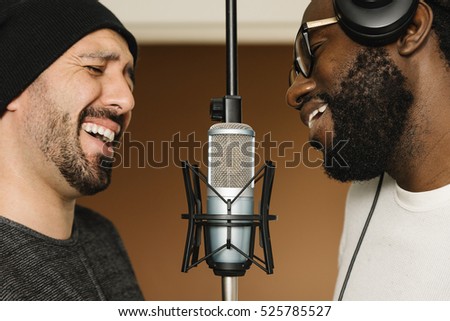 Multiracial artists singing on musical studio.