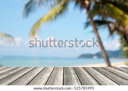 Wood table top and blurred summer beach and sky background. - can used for display or montage your products.