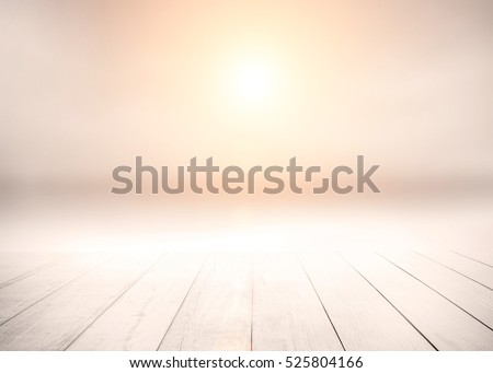 The blur cool sea background with wood floor foreground on horizon tropical sandy beach; relaxing outdoors vacation with heavenly mind view at a resort deck touching sunshine, sky surf summer clouds. Royalty-Free Stock Photo #525804166