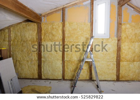termal insulation installing at the attic with metallic ladder Royalty-Free Stock Photo #525829822