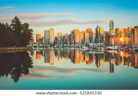 Beautiful view of Vancouver skyline with famous Stanley Park in scenic golden evening light at sunset with retro vintage Instagram style pastel toned filter effect in summer, British Columbia, Canada